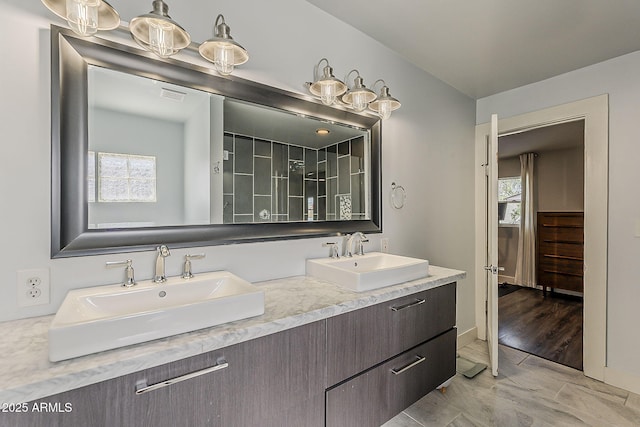 full bath with a sink, visible vents, and a wealth of natural light