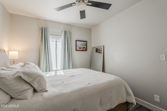 bedroom featuring baseboards, a ceiling fan, and wood finished floors