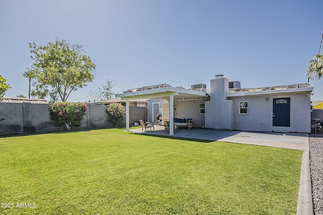 rear view of house featuring a fenced backyard, an outdoor hangout area, a yard, a patio, and stucco siding