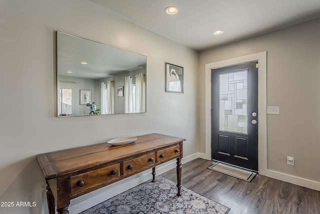entryway with dark wood-type flooring, recessed lighting, and baseboards