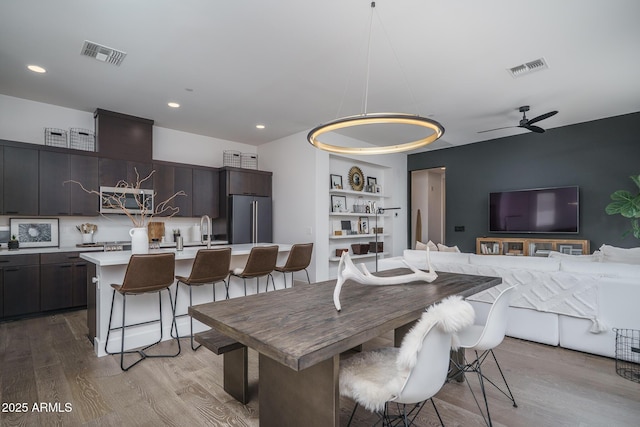 dining area featuring recessed lighting, ceiling fan, light wood finished floors, and visible vents
