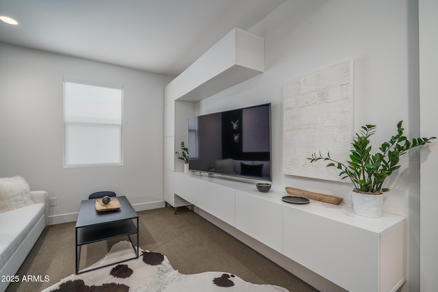 carpeted living area with baseboards
