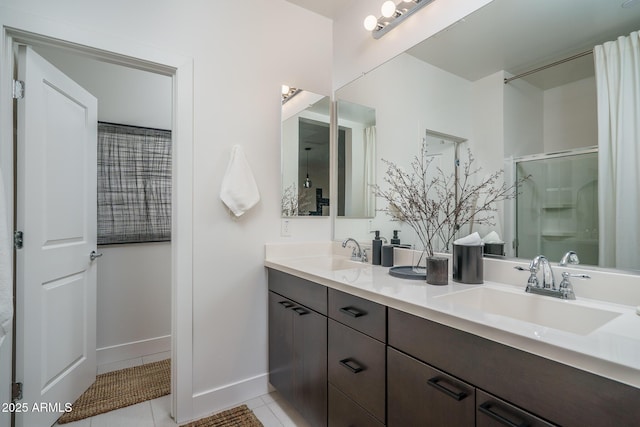 bathroom featuring tile patterned flooring, a sink, a shower with door, and double vanity
