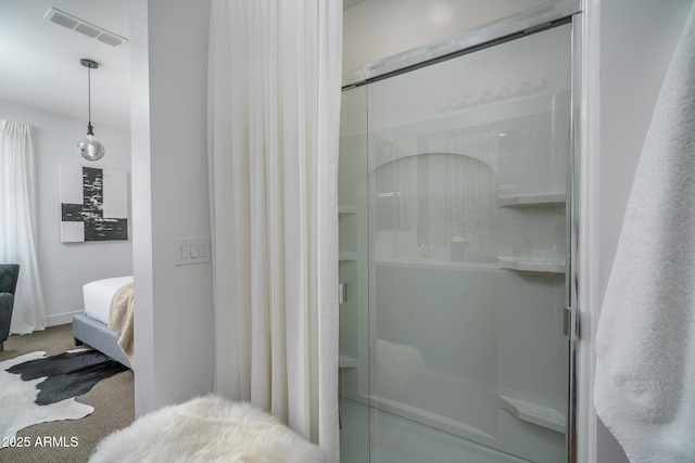 ensuite bathroom with a stall shower, connected bathroom, and visible vents