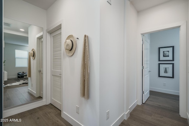 hall featuring recessed lighting, baseboards, dark wood finished floors, and visible vents