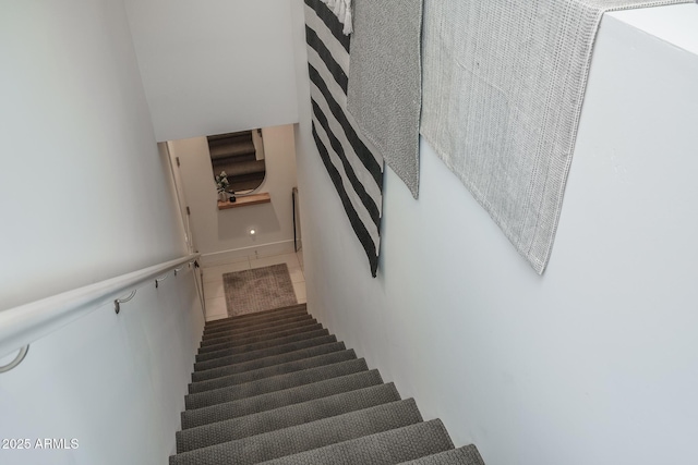 staircase featuring tile patterned flooring
