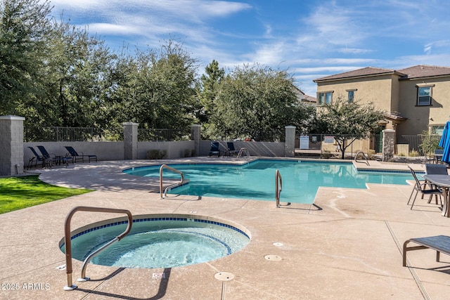 community pool featuring a patio, fence, and a community hot tub