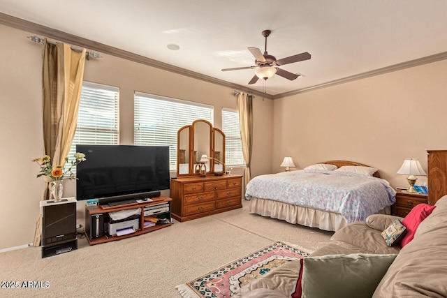 carpeted bedroom featuring crown molding, a ceiling fan, and baseboards