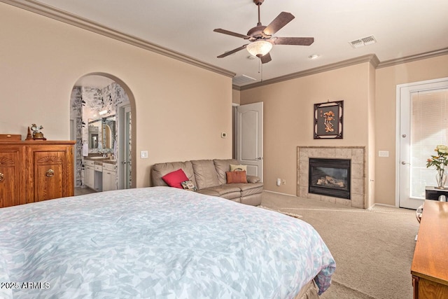 bedroom with visible vents, a fireplace, carpet, and ornamental molding