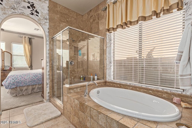 ensuite bathroom featuring ensuite bath, a bath, visible vents, and a stall shower