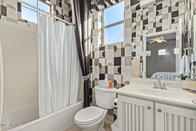 full bathroom featuring vanity, toilet, a ceiling fan, and shower / bath combo