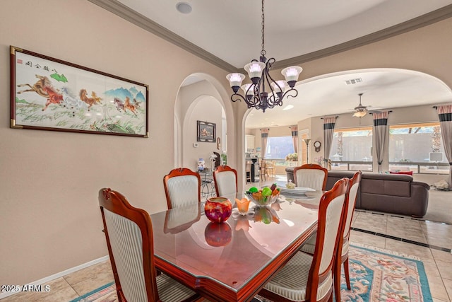 dining room featuring arched walkways, visible vents, a healthy amount of sunlight, and ornamental molding