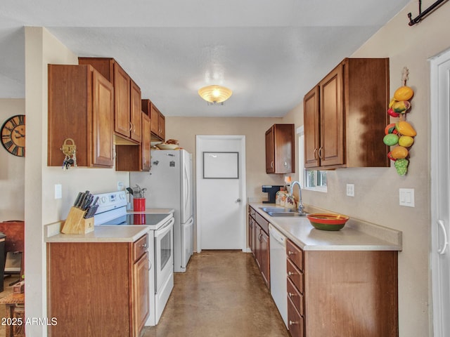 kitchen with white appliances, finished concrete floors, light countertops, and a sink