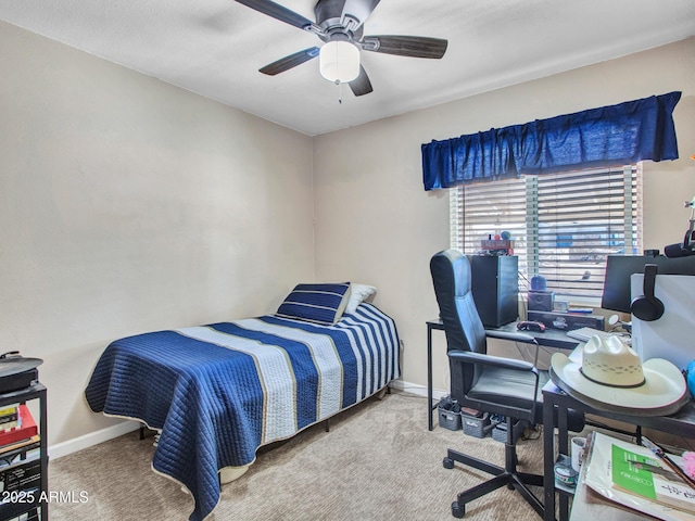 carpeted bedroom with ceiling fan and baseboards