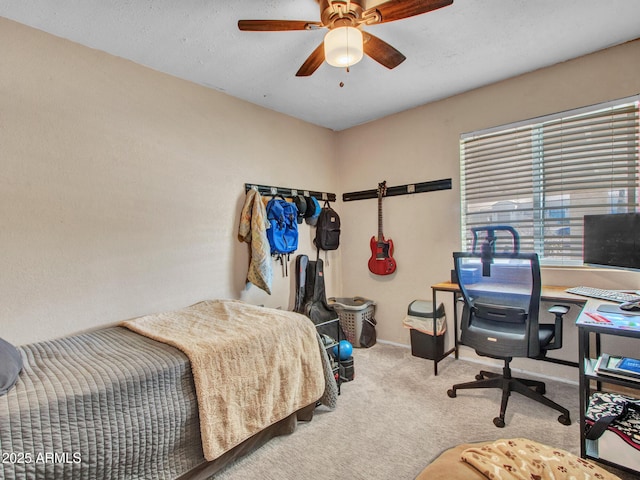 bedroom with ceiling fan, baseboards, and carpet flooring