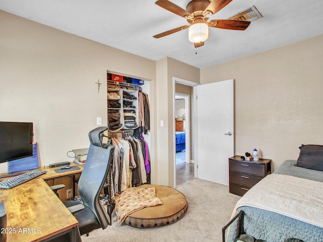 carpeted bedroom with visible vents and a ceiling fan