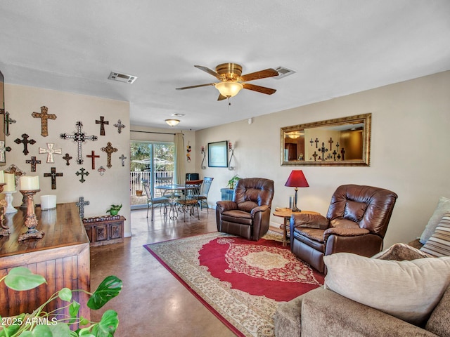 living area featuring finished concrete floors, visible vents, and a ceiling fan