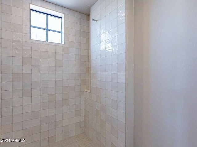 bathroom with a tile shower