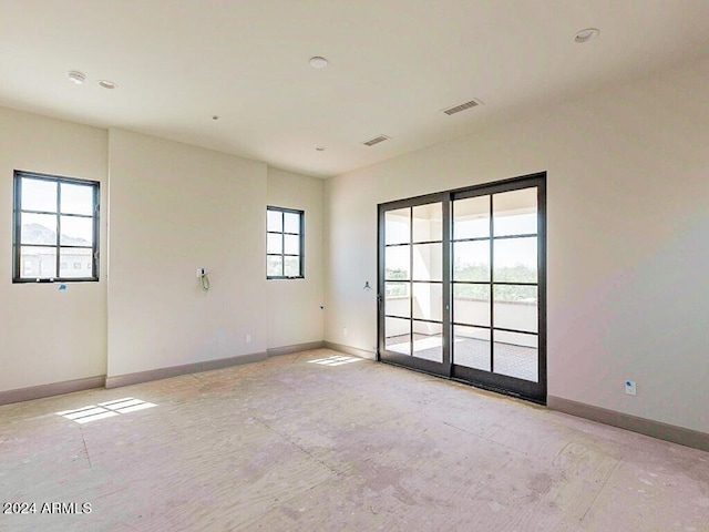 empty room featuring visible vents and baseboards