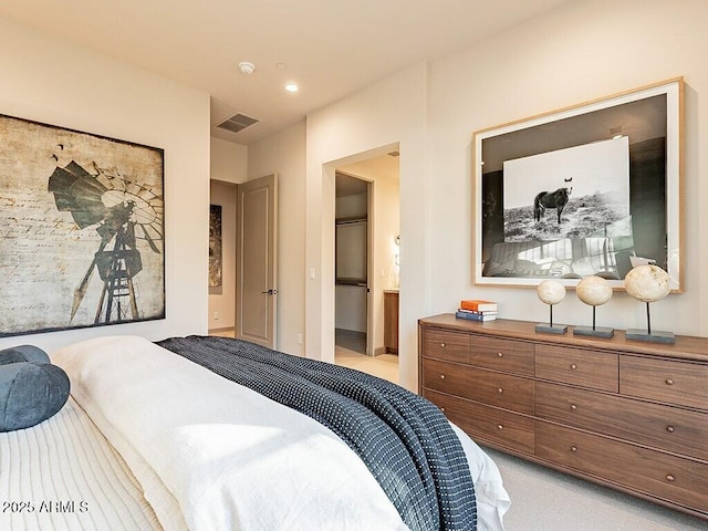 bedroom featuring visible vents and light colored carpet