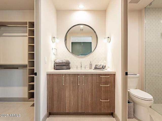 full bath with tile patterned flooring, vanity, and toilet