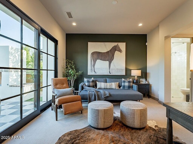 interior space with ensuite bathroom, multiple windows, visible vents, and recessed lighting