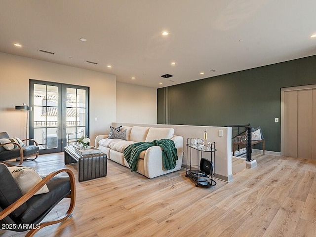 interior space with light wood finished floors, visible vents, access to outside, french doors, and recessed lighting