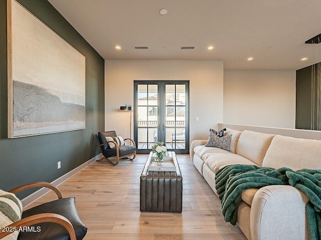 living room featuring recessed lighting, french doors, visible vents, and light wood finished floors