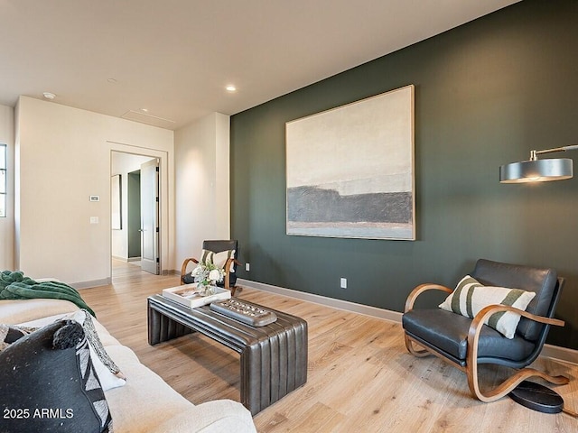 living area with recessed lighting, wood finished floors, and baseboards