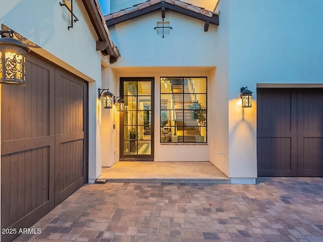 entrance to property featuring stucco siding