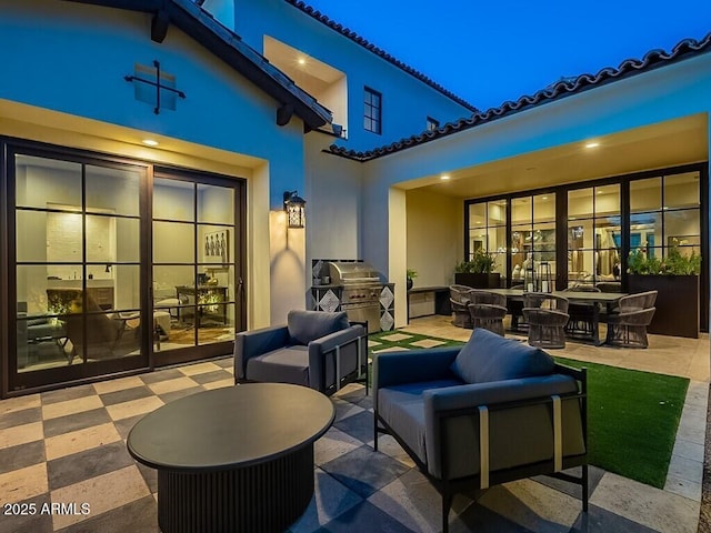 view of patio / terrace featuring a grill, an outdoor hangout area, and french doors