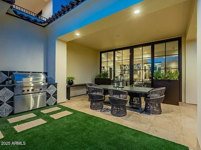 view of patio featuring outdoor dining area, a grill, and an outdoor kitchen