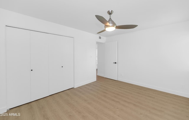 4201 E Camelback Rd Unit 70, Phoenix, AZ 85018 - unfurnished bedroom with light wood finished floors, a closet, baseboards, and ceiling fan