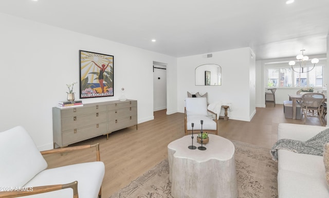 4201 E Camelback Rd Unit 70, Phoenix, AZ 85018 - living area featuring wood finished floors, a chandelier, recessed lighting, and baseboards