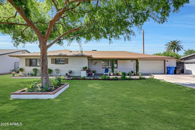 single story home with covered porch, a front yard, concrete driveway, and an attached garage