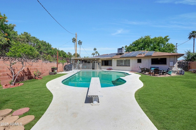 view of pool featuring a patio, a diving board, a fenced in pool, a yard, and a fenced backyard