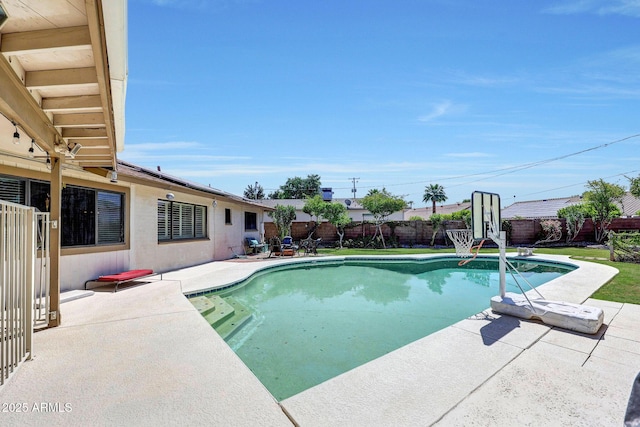 view of swimming pool featuring a fenced in pool, a patio, and a fenced backyard