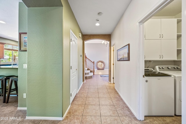 7342 E Norwood St, Mesa, AZ 85207 - corridor featuring washing machine and dryer, light tile patterned floors, a textured wall, stairway, and arched walkways