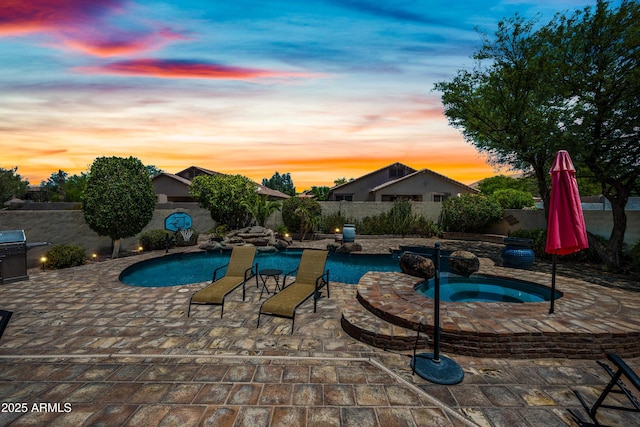 7342 E Norwood St, Mesa, AZ 85207 - pool at dusk featuring an in-ground hot tub, a patio, and a fenced backyard