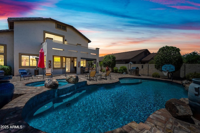 7342 E Norwood St, Mesa, AZ 85207 - pool at dusk featuring a fenced backyard, a patio, area for grilling, and a pool with connected hot tub