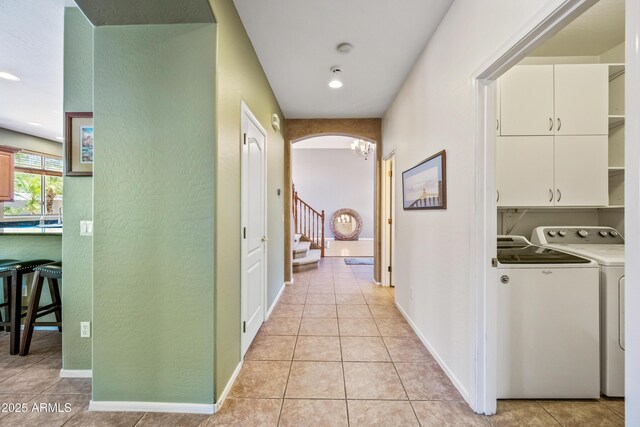 7342 E Norwood St, Mesa, AZ 85207 - corridor featuring washing machine and dryer, light tile patterned floors, a textured wall, stairway, and arched walkways