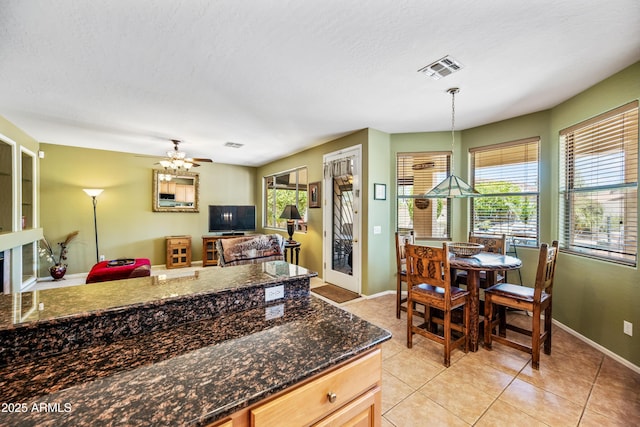 7342 E Norwood St, Mesa, AZ 85207 - kitchen with light tile patterned floors, baseboards, a ceiling fan, open floor plan, and hanging light fixtures