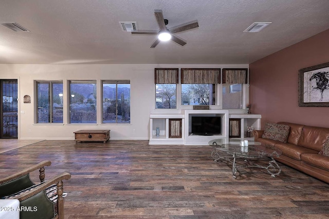 living room with dark wood-type flooring and visible vents