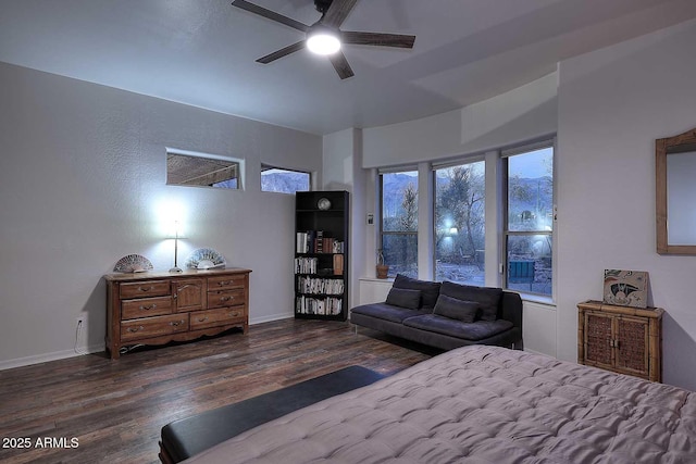 bedroom with ceiling fan, baseboards, and dark wood-style flooring