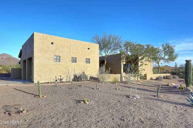 view of side of property featuring stucco siding