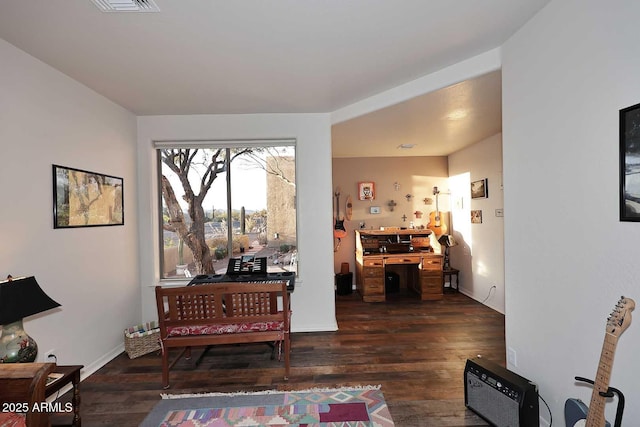 sitting room featuring baseboards, visible vents, and dark wood finished floors