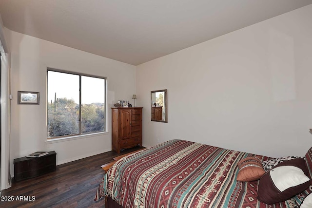 bedroom featuring dark wood-style flooring