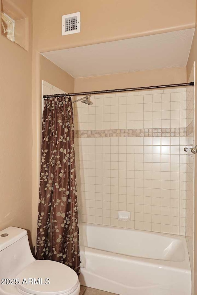 bathroom featuring toilet, visible vents, and shower / bath combination with curtain