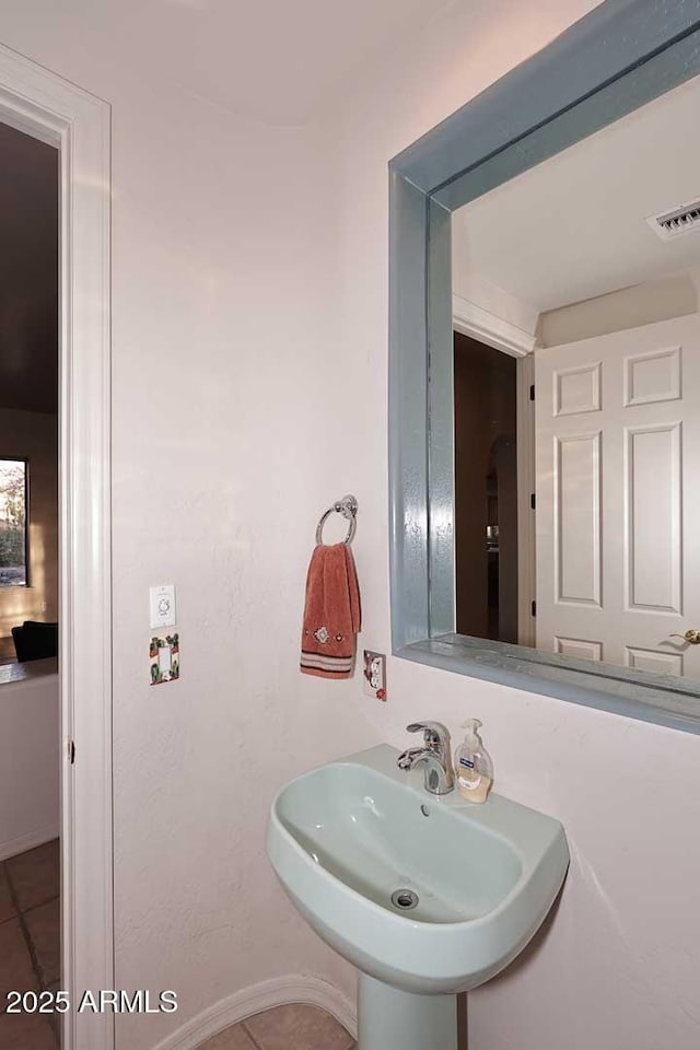 bathroom featuring tile patterned flooring, a sink, and visible vents