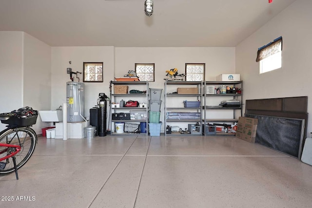 garage featuring a sink and electric water heater